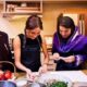 Meghan's publicity blitz continues: Duchess makes dumplings with group of female Afghan refugees in California in video released three days after surprise virtual engagement in UK